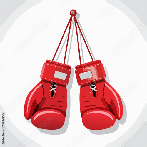 Pair of red boxing gloves hanging by their laces against a white background.