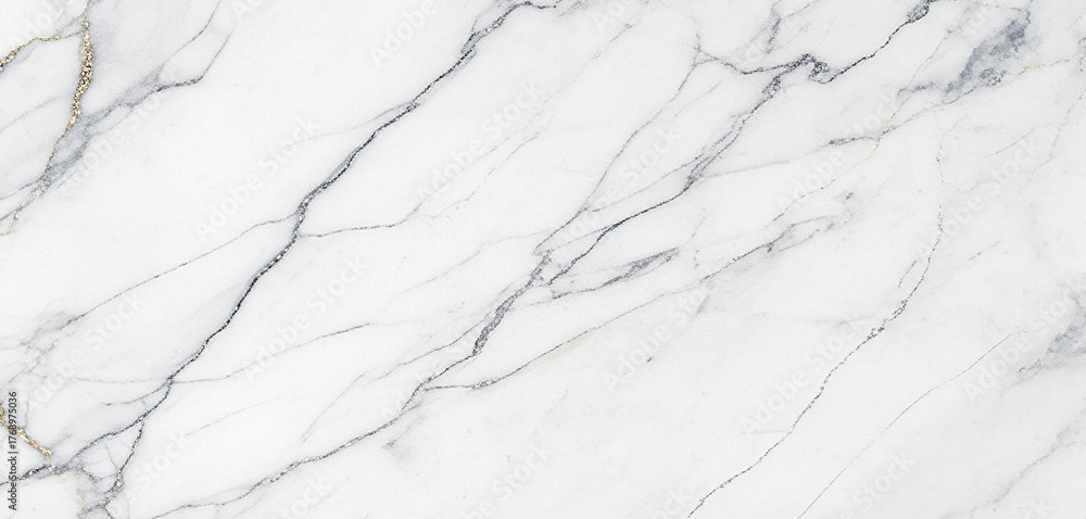 Fototapeta premium White marble surface photographed top-down, showing intricate gray and gold veining details with a smooth reflective texture, softly lit to reveal its refined natural luxury and tonal balance.