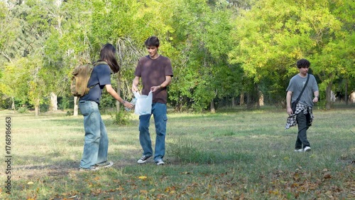 young people collecting garbage in park