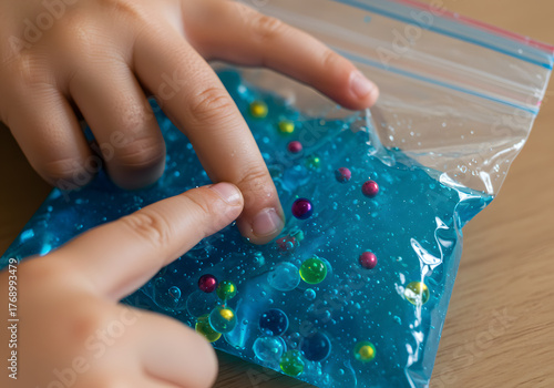 Childs hands explore sensory gel