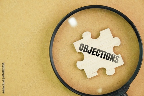 Принти на полотні Magnifying glass and wooden puzzle with the word Objections