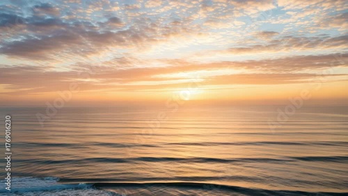 A breathtaking sunrise over the ocean with clouds painting the sky in gold