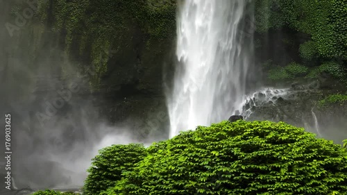 Dreamy powerful stunning waterfall in moody hidden jungle