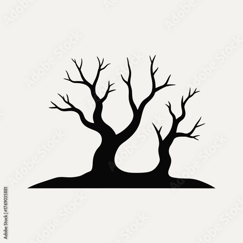 Silhouette of two bare winter trees against a light background