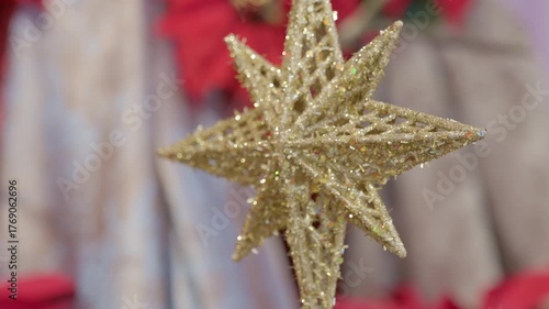 Catholic nativity scene details and decorations. Star. Christmas religious still life with red flowers prayer and faith detail closeup