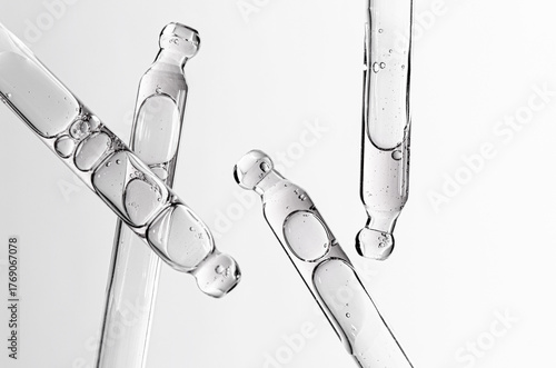 Skin serum in a pipette. A cosmetic product for body care. White background.