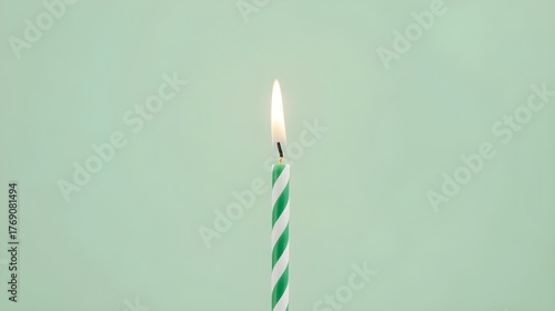 Single Green Candle Flame on Green Background