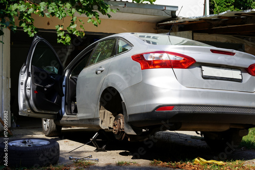 Car repair in a home garage during daylight