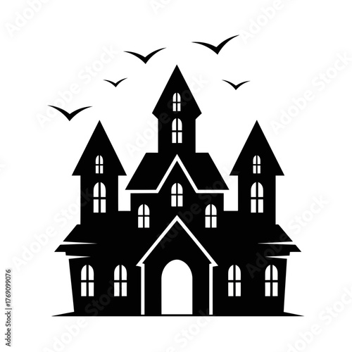 Silhouette of a spooky haunted house with bats flying in the sky