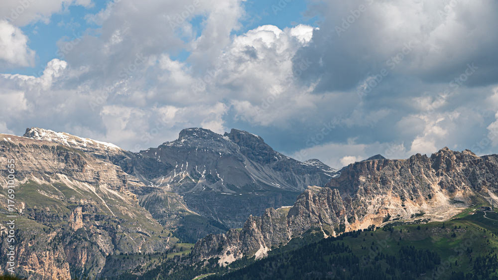 Fototapeta premium Sella mountain range and Sasso Pordoi images from Col Rodella with a cloudy sky in the background, Dolomites, Italy