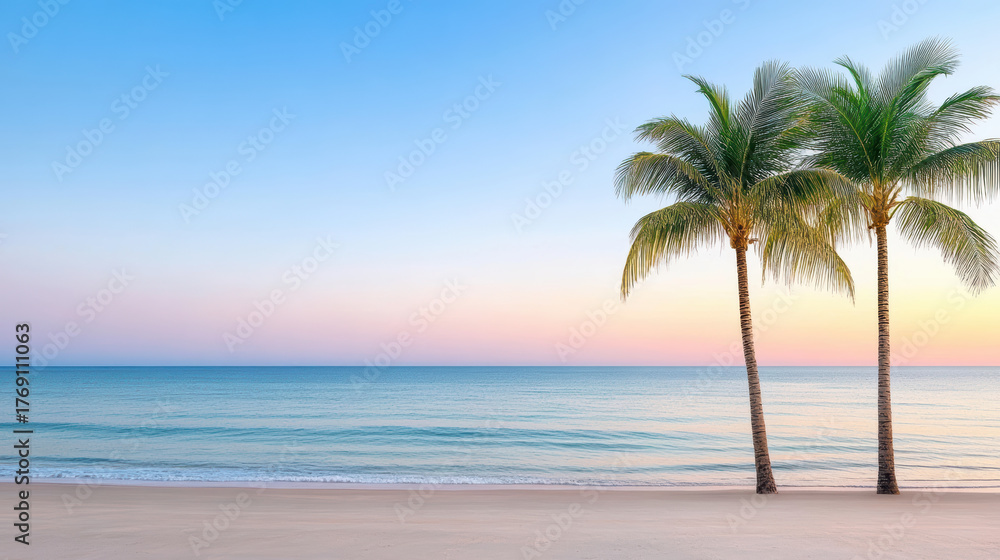 Obraz premium Serene palm trees stand along tranquil beach at sunset, creating peaceful atmosphere