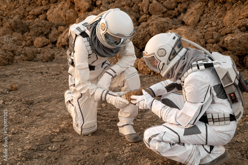 Astronaut team conducting geological analysis of Martian soil during planetary exploration.