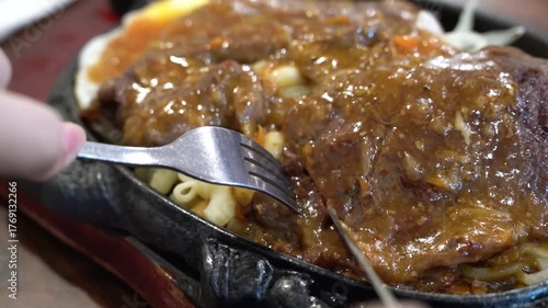 Taiwanese style sizzling beef steak with noodles, egg and black pepper sauce.