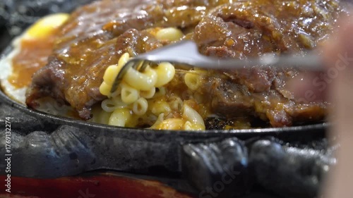 Taiwanese style sizzling beef steak with noodles, egg and black pepper sauce.