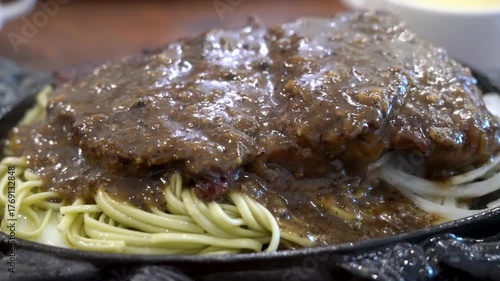 Taiwanese style sizzling beef steak with noodles, egg and black pepper sauce.