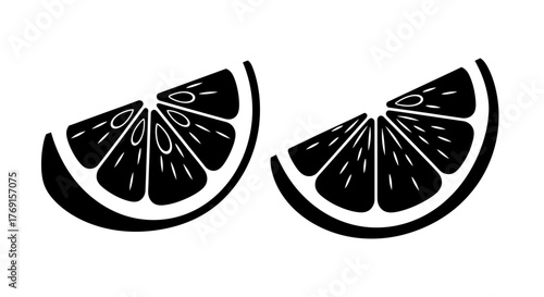 Two slices of orange fruit with detailed segments black and white