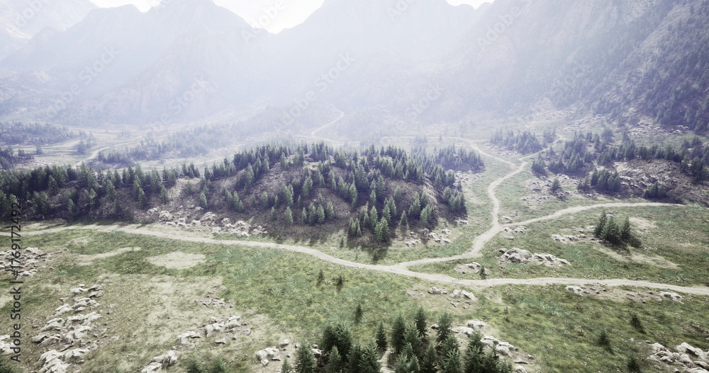 Φωτογραφία A breathtaking view of a mountainous region features lush green forests, rocky terrains, and winding paths beneath a clear sky