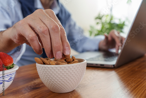 Принти на полотні Enjoying a healthy snack while working at home with laptops and fresh fruits on