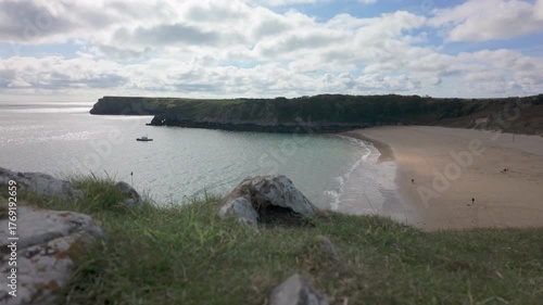 Summertime establishing shot of Barafundle Bay Beach on the Pembrokeshire coast, Wales.