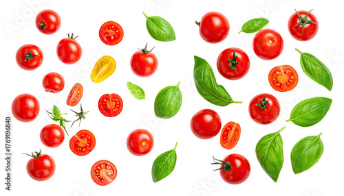 Cherry tomatoes & basil scattered on black, whole, halved, and leaves