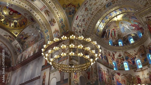 Interior of the People’s Salvation Cathedral in Bucharest, Romania. Majestic Orthodox cathedral with grand arches, golden mosaics, marble columns, and intricate religious frescoes