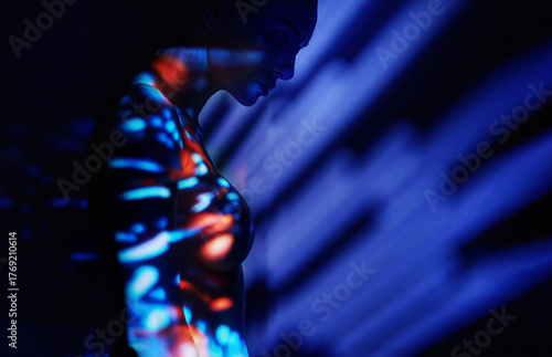 Surreal neon portrait with blue light and abstract digital effects