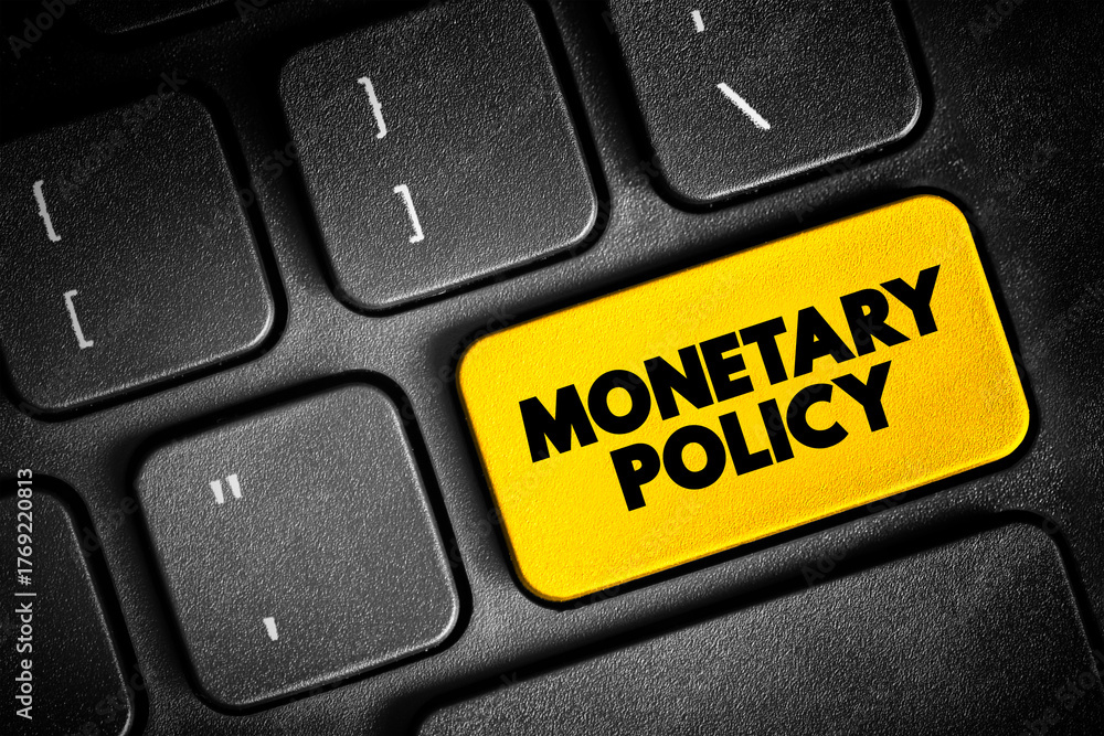 Fototapeta premium Monetary Policy - set of actions to control a nation's overall money supply and achieve economic growth, text button on keyboard, concept background