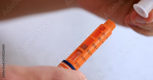 Attaching Needle to Orange Insulin Pen in 4K Slow Motion