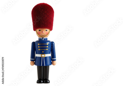 Isolated toy figurine of a wooden soldier in traditional uniform and red bearskin hat, toy shop