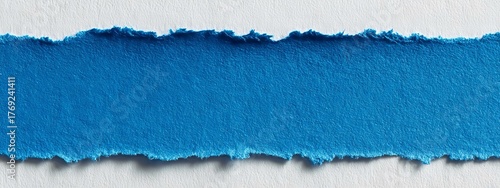 Striscia di carta blu, strappata con un bordo irregolare, disposto orizzontalmente su uno sfondo grigio.