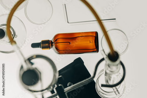 Amber glass bottle with dropper in a chemical laboratory setting for fragrance invention