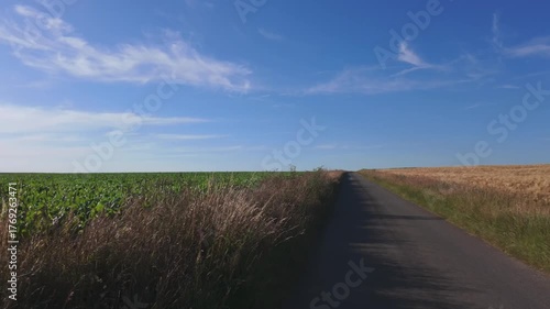 Bergnicourt, Rethel, Ardennes, Grand-Est, France, August, 28th, 2025, A picturesque view of a road bordered by lush fields, perfect for nature lovers and travel enthusiasts.