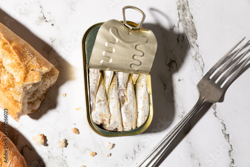 Canned sardines and bread isolated on kitchen countertop