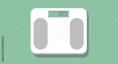 A white digital scale on a green surface displays the number 1000 It has gray foot pads