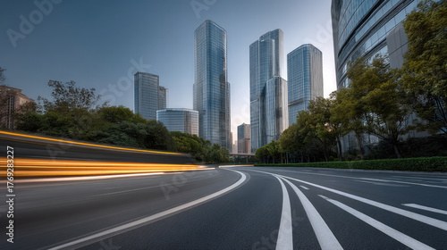Modern cityscape with glass skyscraper, curved road, motion blur, urban trees, and clear sky at dusk, evoking dynamic city energy