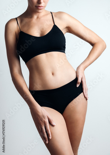 Beautiful woman with healthy body posing over white background.