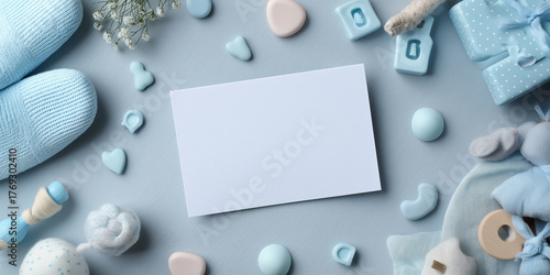 Blank milestone card is surrounded by pastel blue baby items, including booties, toys, and decorative hearts, creating soft and charming atmosphere