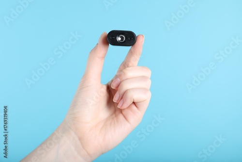 Wallpaper Mural Woman with hidden spy camera on light blue background, closeup Torontodigital.ca