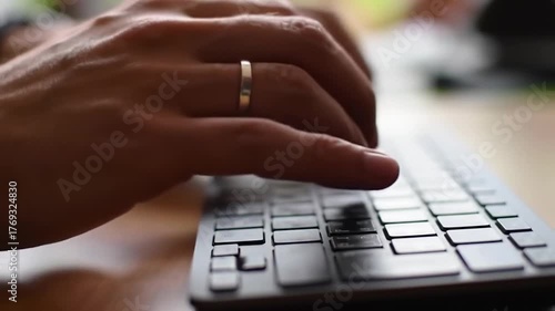 Typing on a keyboard close up of hands and fingers on computer keypad