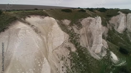 White cliffs and birds flock overhead nature scenery environment
