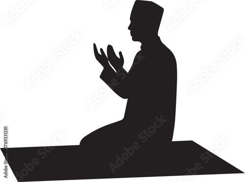 Silhouette of a muslim man kneeling in prayer on a rug hands raised in supplication silhouette
