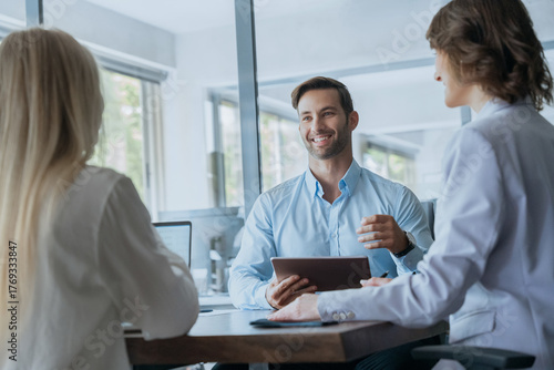 Photos Young real estate manager worker man talking with bank client in office