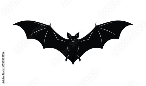 Silhouette of a black bat with wide open wings in flight