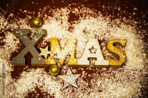 Xmas letters in snow with golden decorations