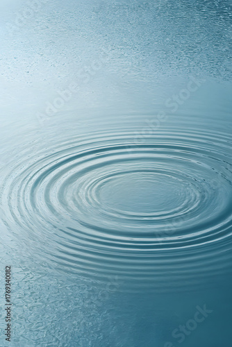 Circles on Water: Capturing the essence of tranquility, concentric rings ripple outwards across a serene water surface, reflecting the sky above.