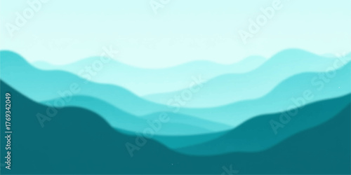Abstract blue waves on the beach at sunrise with a scenic mountain range and mist