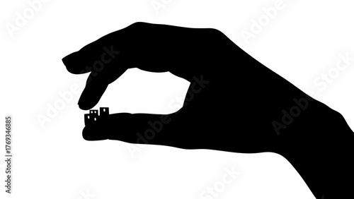 A hand delicately holds tiny buildings, showcasing real estate investment or urban planning concept