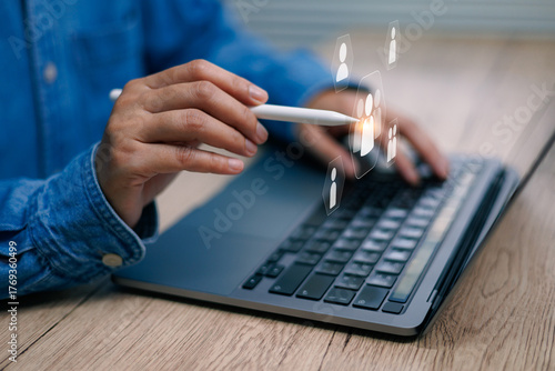 Hand using pen stylus pointing on laptop digital screen connecting user icons, concept of human virtual resources, social media, communication, and technology