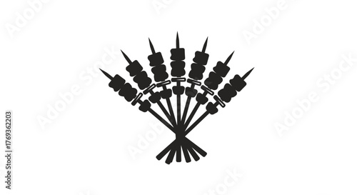 A fan shaped arrangement of black skewers with food on skewers