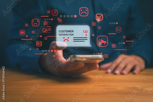 Customer holding smartphone showing one-star negative review and sad face icon, representing poor service, bad experience, and low satisfaction in online business or digital feedback concept.